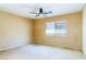 Neutral bedroom features a ceiling fan and natural light from a window at 5040 Copperlyn St, Las Vegas, NV 89122
