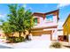 Charming two-story home featuring a two-car garage and mature landscaping at 5040 Copperlyn St, Las Vegas, NV 89122