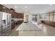 Elegant kitchen featuring stainless steel appliances, granite countertops, and a breakfast bar overlooking the living space at 5344 Bocopa St, Las Vegas, NV 89148