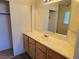 Bright bathroom with wood cabinets and vanity at 5406 Indigo Hills St, North Las Vegas, NV 89031