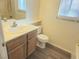 Bathroom features a vanity with storage and a toilet with wood-look flooring at 5406 Indigo Hills St, North Las Vegas, NV 89031
