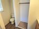 The toilet and closet area featuring wood look floors and a small window at 5406 Indigo Hills St, North Las Vegas, NV 89031