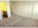 The bedroom features carpet, a doorway to the bathroom, and double closets at 5406 Indigo Hills St, North Las Vegas, NV 89031