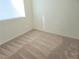 Bright carpeted bedroom has neutral walls and blinds on the window at 5406 Indigo Hills St, North Las Vegas, NV 89031