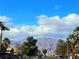 A view of the street with mountain backdrop, trees, and residential homes at 5406 Indigo Hills St, North Las Vegas, NV 89031