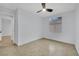 This bedroom features tile flooring, a ceiling fan, and a bright window at 5533 Ramirez St, North Las Vegas, NV 89031