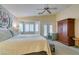 Relaxing bedroom featuring neutral tones, a large bed, and shuttered windows creating a serene atmosphere at 5717 Calm Lagoon Ave, Las Vegas, NV 89130