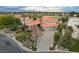 Luxury home with a sprawling driveway, mature trees, a manicured lawn, and views of the mountains at 60 Innisbrook Ave, Las Vegas, NV 89113