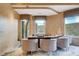 Cozy bar area with barstool seating, pendant lighting and backyard views at 60 Innisbrook Ave, Las Vegas, NV 89113