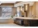 Bathroom featuring a soaking tub, vanity, and decorative window and lighting at 60 Innisbrook Ave, Las Vegas, NV 89113