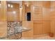 Unique bathroom with light wood paneling, a mosaic backsplash, and a modern glass bowl sink at 60 Innisbrook Ave, Las Vegas, NV 89113