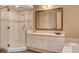 Bright bathroom featuring a glass shower, large mirror, and neutral tones at 60 Innisbrook Ave, Las Vegas, NV 89113