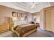 Relaxing bedroom features a decorative headboard, tray ceilings, and a sitting area at 60 Innisbrook Ave, Las Vegas, NV 89113