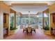 Elegant dining room featuring a chandelier and views of the outdoor pool and cabana at 60 Innisbrook Ave, Las Vegas, NV 89113