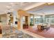 Dining room with chandelier, large windows overlooking pool, bar area and artistic rugs at 60 Innisbrook Ave, Las Vegas, NV 89113