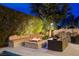 Inviting outdoor fire pit area with built-in seating, perfect for entertaining at 60 Innisbrook Ave, Las Vegas, NV 89113
