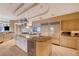 Gourmet kitchen features stainless steel appliances, a center island with a cooktop and a wine refrigerator at 60 Innisbrook Ave, Las Vegas, NV 89113