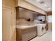 Laundry room features modern appliances, granite countertops, and ample cabinet space at 60 Innisbrook Ave, Las Vegas, NV 89113
