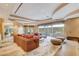 Spacious living room with recessed lighting, sectional sofa and views to the backyard at 60 Innisbrook Ave, Las Vegas, NV 89113