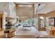 Open-concept living area with a pool table, bar, and abundant natural light at 60 Innisbrook Ave, Las Vegas, NV 89113