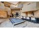 Spacious living area with a bar, pool table, and spiral staircase leading to the second floor at 60 Innisbrook Ave, Las Vegas, NV 89113