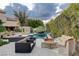 Luxurious backyard with a refreshing pool, fire pit, and comfortable seating areas at 60 Innisbrook Ave, Las Vegas, NV 89113