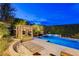 The backyard features a lovely pool, lounge chairs, and a covered cabana at 60 Innisbrook Ave, Las Vegas, NV 89113