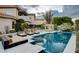 Beautiful pool area with sun loungers, mature trees, and outdoor living space at 60 Innisbrook Ave, Las Vegas, NV 89113