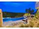 The backyard has a lovely pool, lounge chairs, and manicured landscaping at 60 Innisbrook Ave, Las Vegas, NV 89113