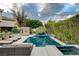 Inviting backyard oasis with a sparkling pool, spa, lounge chairs, and a covered cabana at 60 Innisbrook Ave, Las Vegas, NV 89113