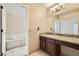Bathroom with granite countertop and bathtub at 6151 Whispering Sands Dr, Las Vegas, NV 89131
