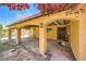 Charming home with covered patio, arched doorways, terracotta roof and a water fountain feature at 6151 Whispering Sands Dr, Las Vegas, NV 89131