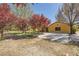 Charming home exterior with mature trees, providing shade and curb appeal, set on a spacious lot at 6151 Whispering Sands Dr, Las Vegas, NV 89131