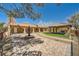 Spacious front yard featuring a water fountain, covered walkways, and lush landscaping at 6151 Whispering Sands Dr, Las Vegas, NV 89131