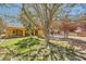 Expansive front lawn with mature trees and landscaping, creating a serene setting at 6151 Whispering Sands Dr, Las Vegas, NV 89131