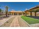 Charming single-story home with a terracotta roof, well-manicured lawn, and beautiful water fountain at 6151 Whispering Sands Dr, Las Vegas, NV 89131