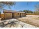 A functional horse barn and expansive dirt area ready for customization for equestrian needs at 6151 Whispering Sands Dr, Las Vegas, NV 89131