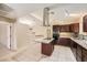 Bright kitchen with granite countertops, modern appliances, an island cooktop, and a stainless steel range hood at 6151 Whispering Sands Dr, Las Vegas, NV 89131