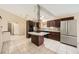 Open kitchen with granite countertops, a large refrigerator, modern appliances, and an island cooktop at 6151 Whispering Sands Dr, Las Vegas, NV 89131