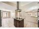 Open kitchen with granite countertops, a central island cooktop, modern appliances, and ample storage at 6151 Whispering Sands Dr, Las Vegas, NV 89131