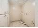 Functional laundry room with tiled floors, neutral walls, and ample cabinet space for storage at 6151 Whispering Sands Dr, Las Vegas, NV 89131