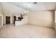 Large, tiled living room adjacent to kitchen offers ample space for entertaining guests and Gathering gatherings at 6151 Whispering Sands Dr, Las Vegas, NV 89131
