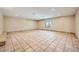Bright living room featuring tiled flooring, neutral walls, and natural light from the window at 6151 Whispering Sands Dr, Las Vegas, NV 89131