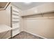 Walk-in closet with custom shelving and desk area offers great space-saving design for organization and storage at 6151 Whispering Sands Dr, Las Vegas, NV 89131