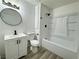 Bright bathroom with a vanity, updated fixtures, and a bathtub with shower at 6174 Meadowgrass Ln, Las Vegas, NV 89103