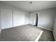 Light-filled bedroom boasts plush carpet, double closets and access to the bathroom at 6174 Meadowgrass Ln, Las Vegas, NV 89103