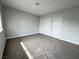 Bright bedroom features plush carpeting and sliding closet doors, offering plenty of storage at 6174 Meadowgrass Ln, Las Vegas, NV 89103