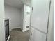 Hallway with carpeted floors, storage cabinets, and a door with a window at 6174 Meadowgrass Ln, Las Vegas, NV 89103