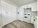 Updated kitchen with new appliances and modern flooring at 6174 Meadowgrass Ln, Las Vegas, NV 89103