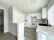 Modern kitchen featuring white cabinets, stainless steel appliances, and stone countertops at 6174 Meadowgrass Ln, Las Vegas, NV 89103